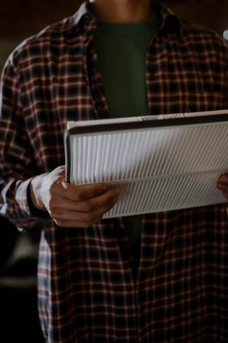 Person holding a new pleated air filter