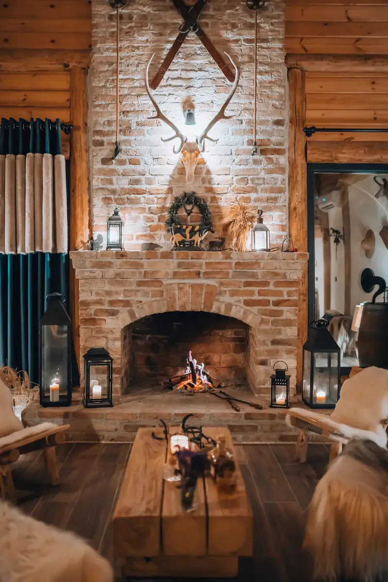 Cozy living room with a lit brick fireplace and candles on a winter evening